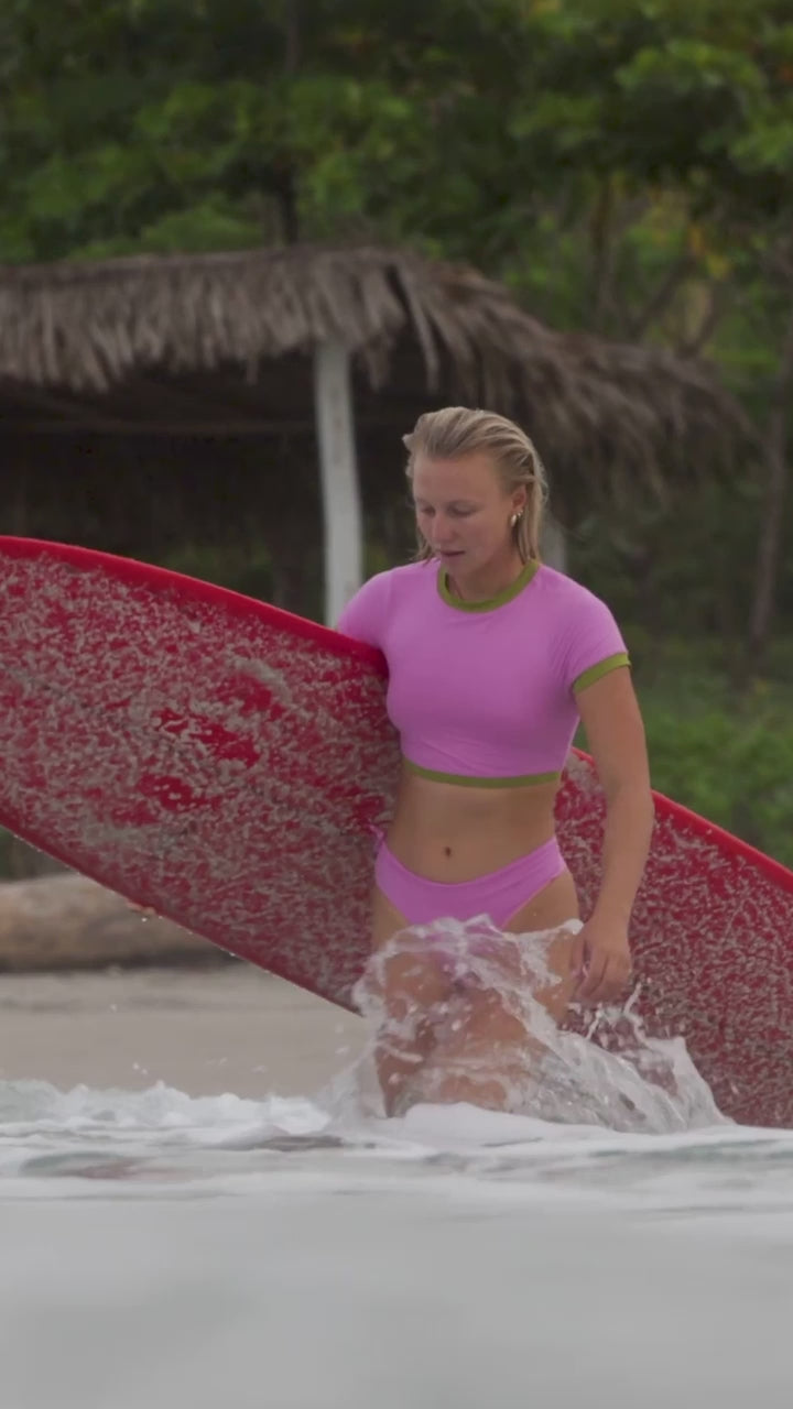 Delilah Surfing in Guiones Costa Rica with the tropical bottom