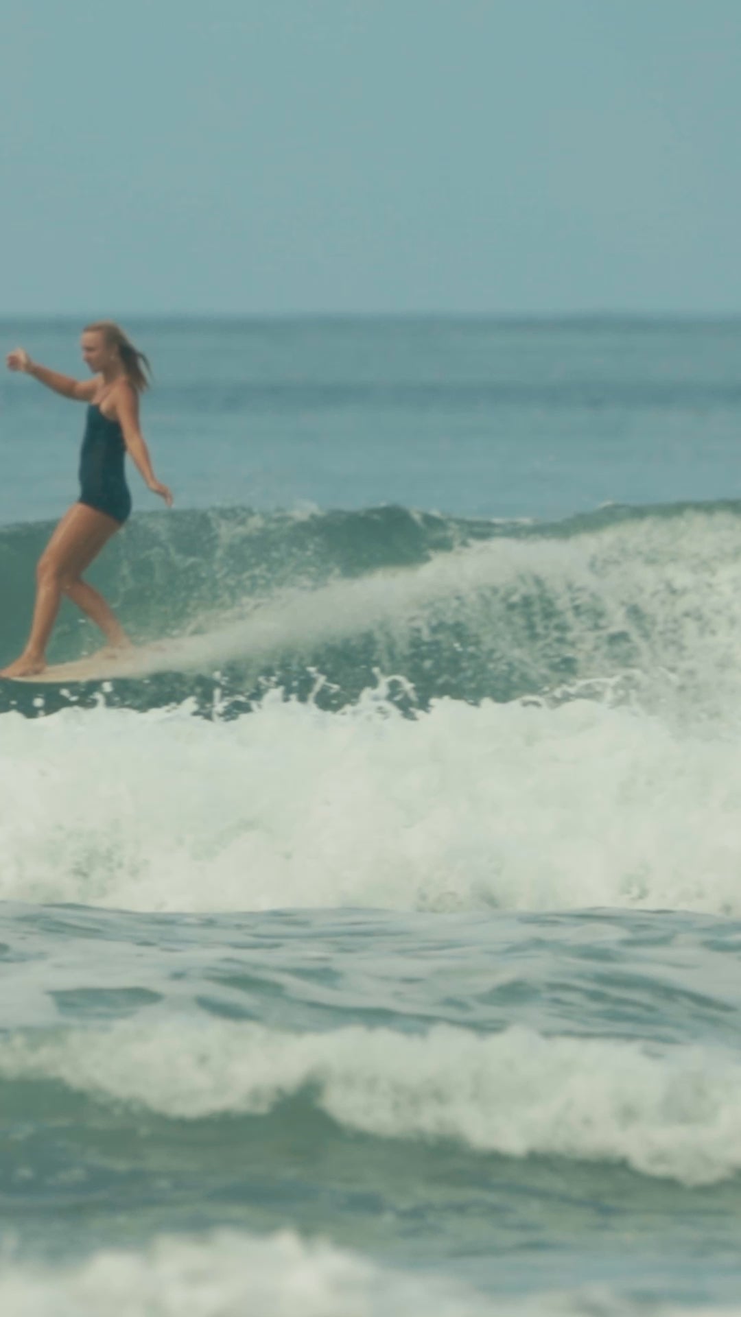 Delilah Surfing Santa Teresa Costa Rica with her Shine One Piece Surf Suit