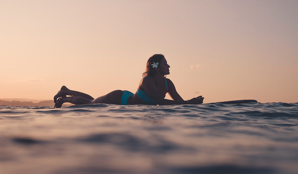 Marie surfing at a beautiful sunset in Australia